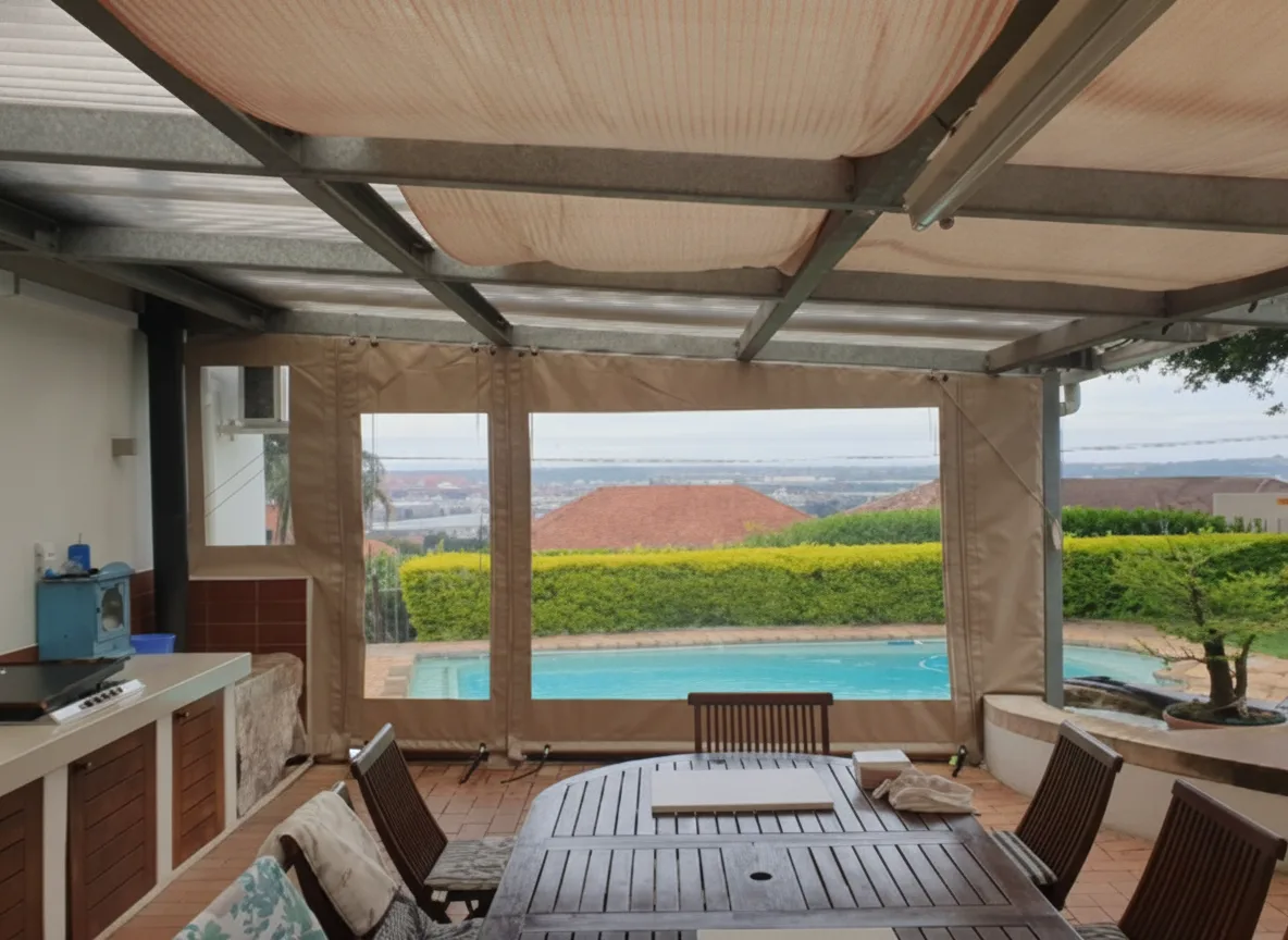 Covered patio with a retractable shade awning and drop-down PVC blinds with large clear view panels, overlooking a pool and valley